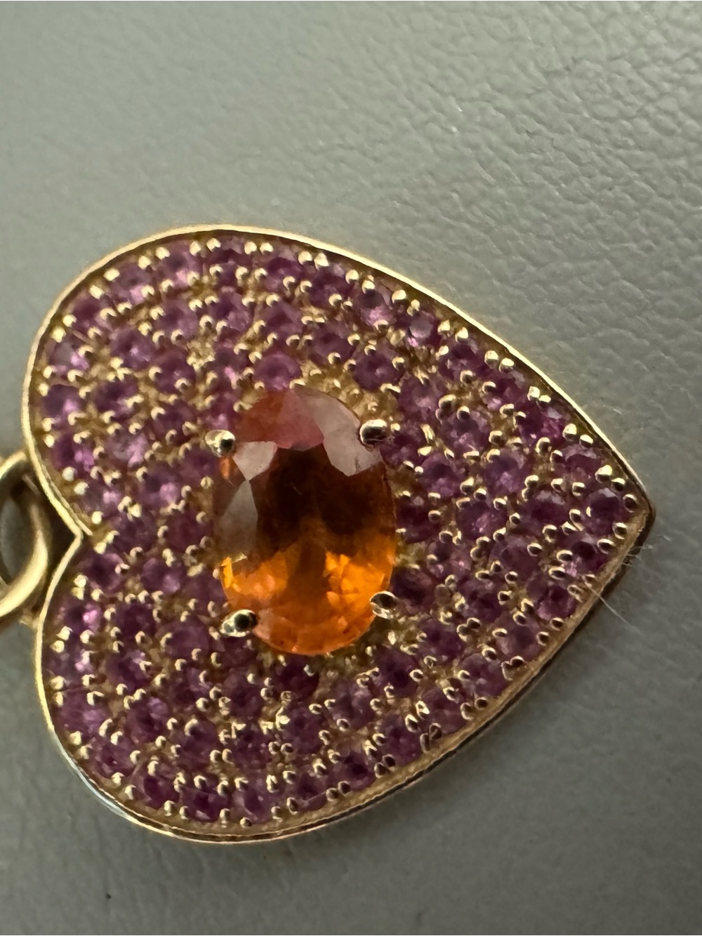 14k gold heart with pink sapphire and orange sapphire in the middle
